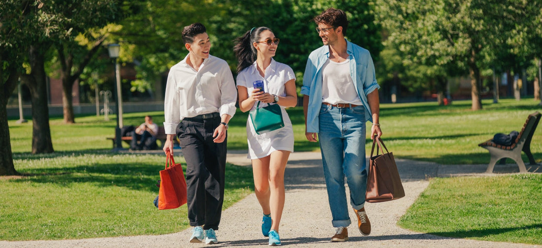 Young adults enjoying a walk together in a sunny urban park