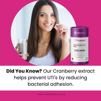 Woman holding probiotic capsule and water glass next to Femina Cranberry Probiotics for fertility and urinary health in C-Essentials Kit